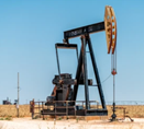 Image of an oil drilling rig on a land-based site.
