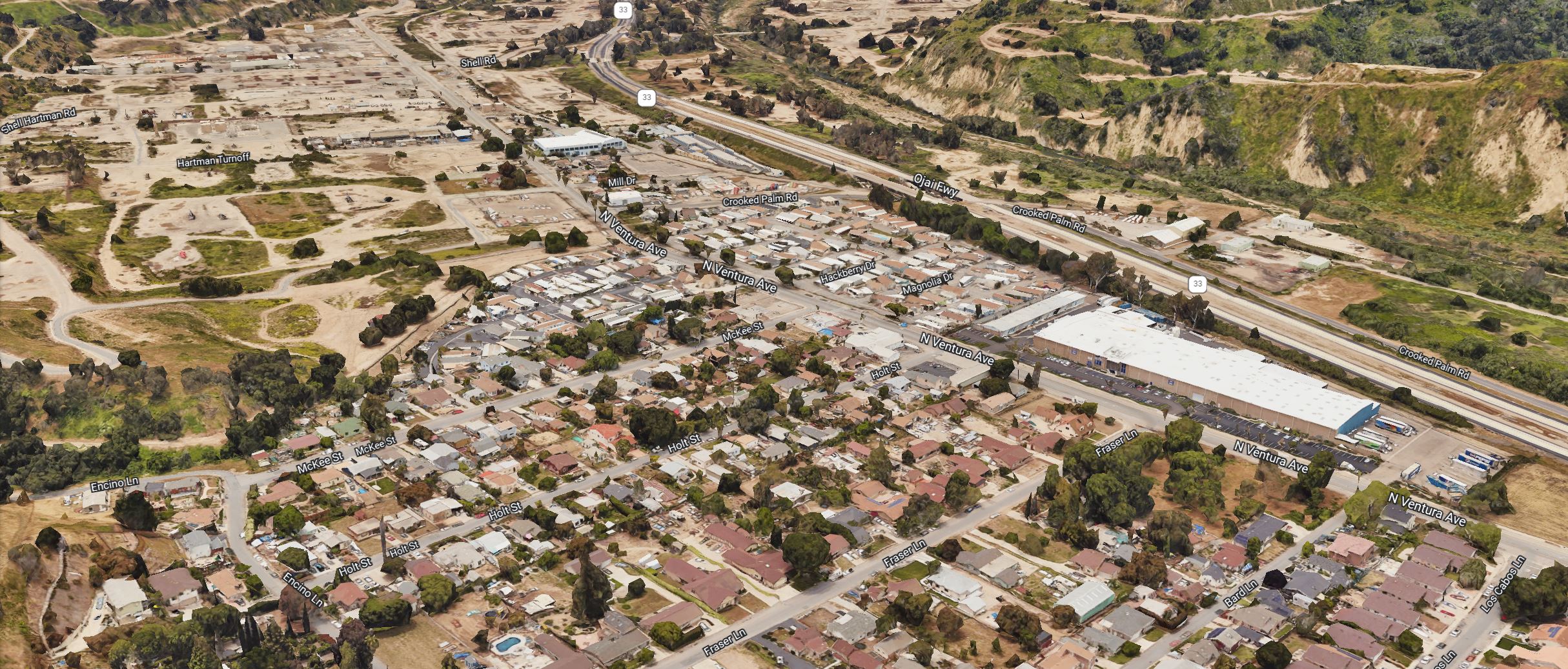 Aerial view of homes and commercial buildings next to a river.